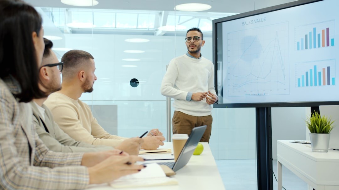 Team of Belgian entrepreneurs reviewing growth charts in a modern office